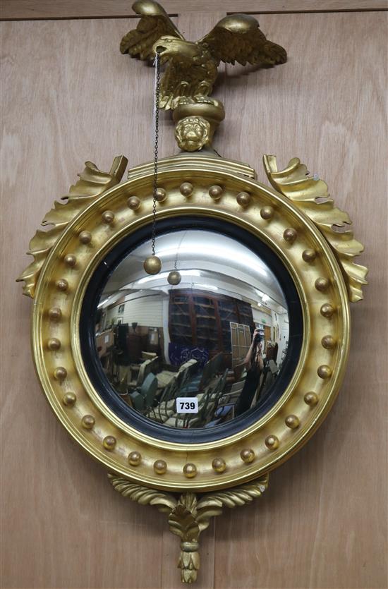 A Regency gilt carved wood convex wall mirror W.52cm